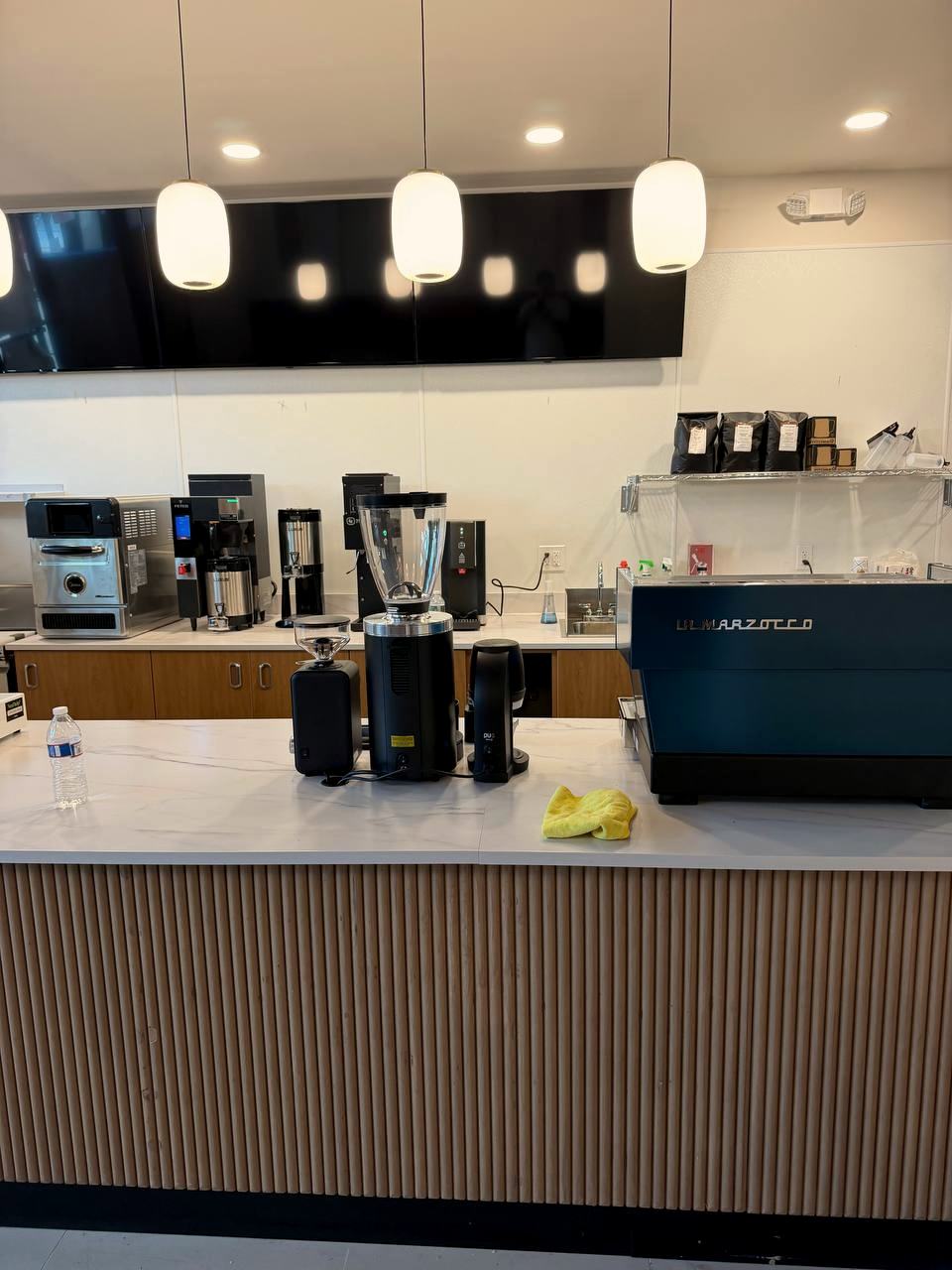 Burst Beans Coffee — back bar with rattan pendants and equipment